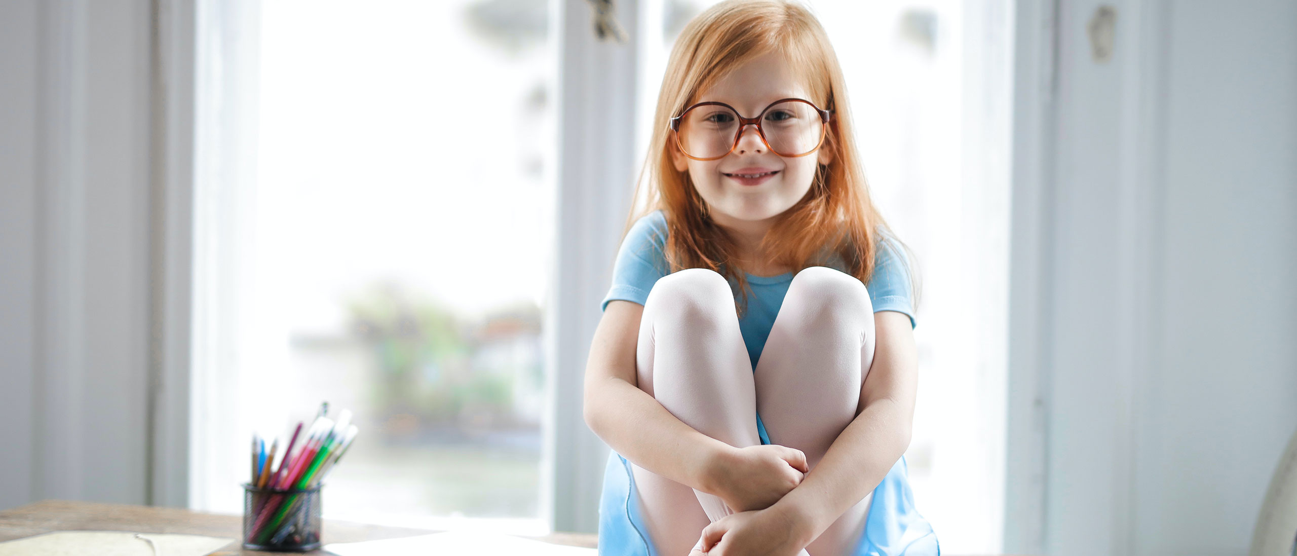 Girl with glasses sitting banner-11